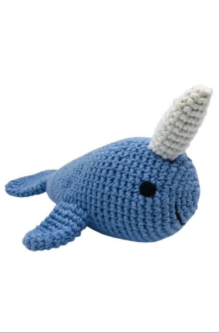 A blue crocheted narwhal plush toy with a white horn and small black eyes, shown on a plain white background.