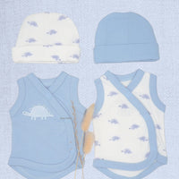 A baby clothing set laid flat on a pale blue textured background, including a light blue beanie, a cream beanie with small blue dinosaur prints, a light blue wrap vest with a dinosaur graphic, and a cream wrap vest with blue dinosaur prints and blue trim.