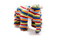 A knitted stuffed elephant toy with horizontal rainbow stripes in red, orange, yellow, green, blue, and white, featuring brown ears and trunk base, photographed on a white background.