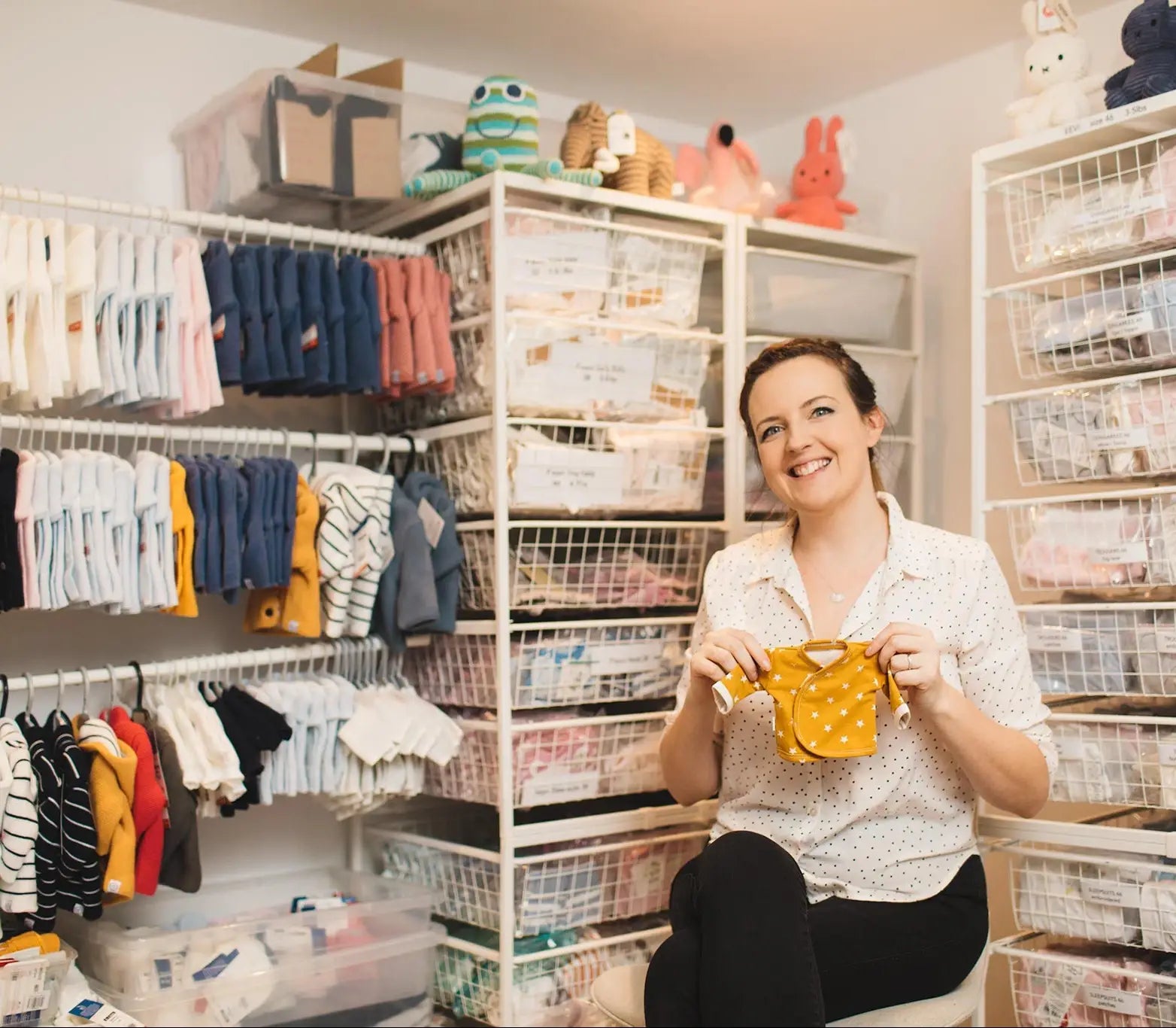 NICU Nurse holding tiny baby clothing