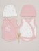 A baby clothing set laid flat on a light beige fabric background, including a white knit beanie with tiny pink floral prints, a solid light pink beanie, a pink wrap vest with white floral embroidery, and a white wrap vest with pink trim and small pink floral prints. A small dried decorative stem sits between the garments.