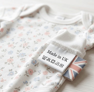 Floral tiny baby outfit with 'Made in UK' label on a white background