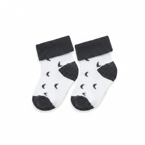 Pair of baby socks with black patterns on a white background