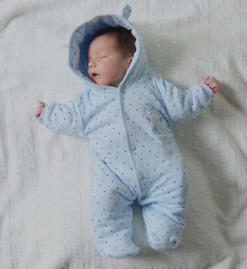 Boy in tiny baby snowsuit