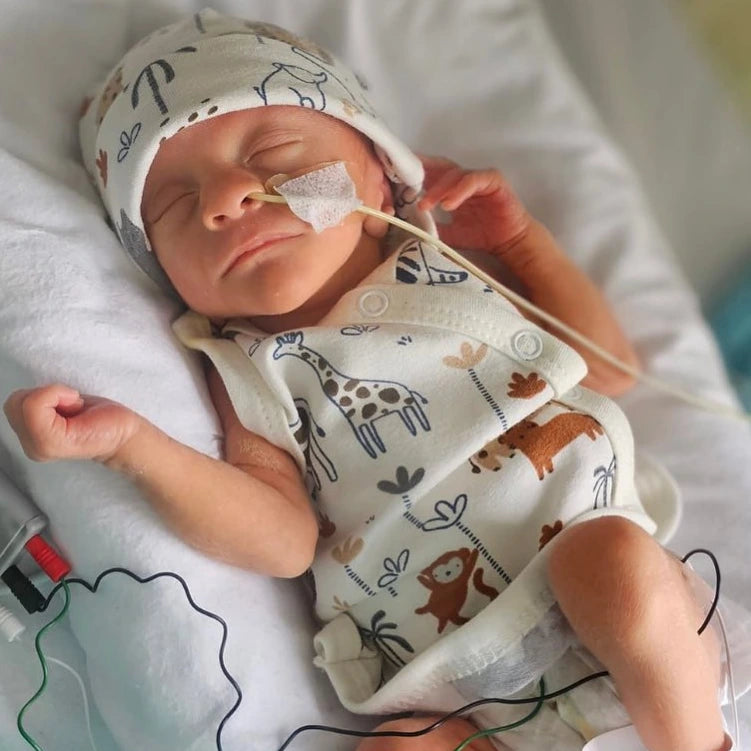 Newborn baby in a hospital setting with medical equipment